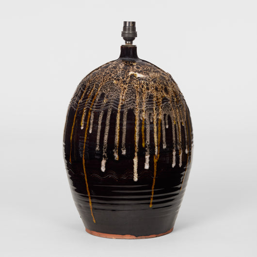 A LARGE VASE LAMP IN A DARK BROWN GLAZE WITH DRIP DECORATION TO THE UPPER SECTION, LATE 20TH CENTURY.
