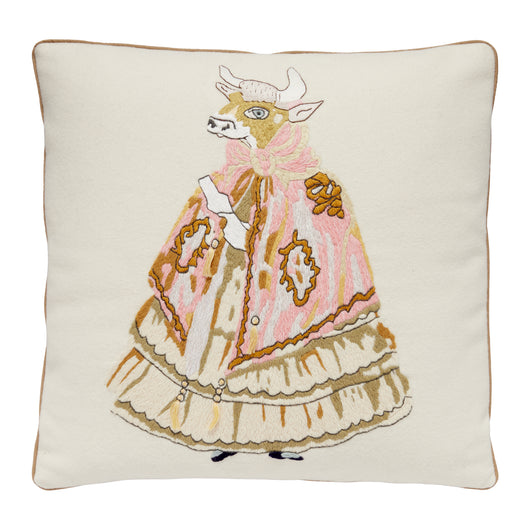 A NEEDLEPOINT CUSHION OF A COW IN A DRESS INSPIRED BY NANCY LANCASTER'S TABLECLOTH