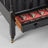 A MID-20TH CENTURY CANTERBURY WITH FOUR SECTIONS AND A SLIM DRAWER TO THE BASE, WITH A LATER EBONSIED FINISH.