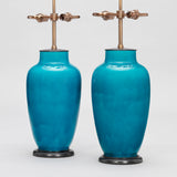 A PAIR OF FRENCH POTTERY VASES IN A DEEP TURQUISE GLAZE, MID-20TH CENTURY, WIRED AS LAMPS.