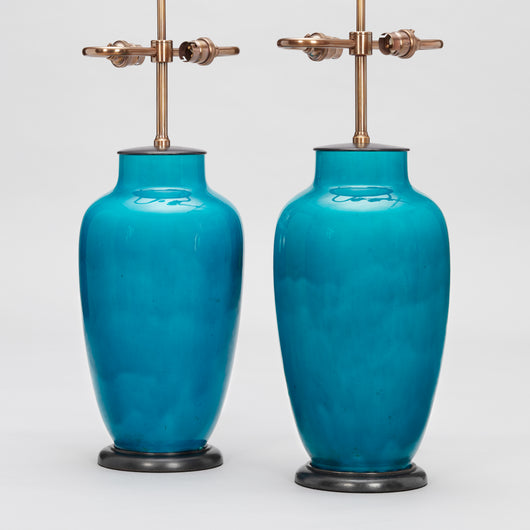 A PAIR OF FRENCH POTTERY VASES IN A DEEP TURQUISE GLAZE, MID-20TH CENTURY, WIRED AS LAMPS.
