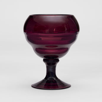 A GOBLET SHAPED AMETHYST GLASS VASE.