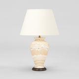 A SMALL ONYX INVERTED BALUSTER SHAPED BASE WIRED AS A LAMP.