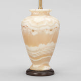 A SMALL ONYX INVERTED BALUSTER SHAPED BASE WIRED AS A LAMP.