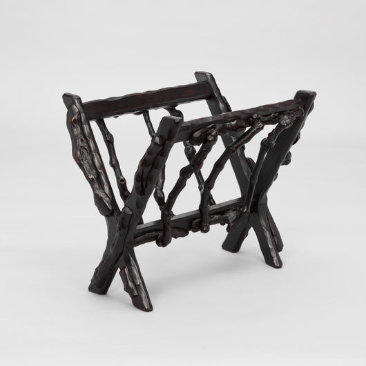 AN EARLY 19TH CENTURY FRENCH VINE-WOOD MAGAZINE STAND OF WEDGE-SHAPE FORM WITH A DARK WAXED FINISH.