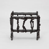 AN EARLY 19TH CENTURY FRENCH VINE-WOOD MAGAZINE STAND OF WEDGE-SHAPE FORM WITH A DARK WAXED FINISH.