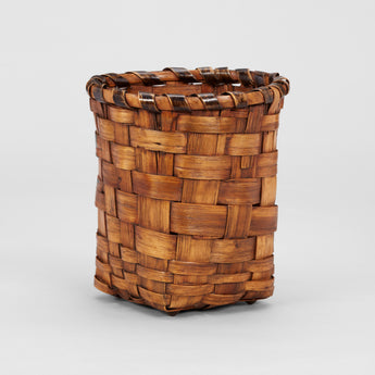 A WOVEN SPLIT CANE PAPER BASKET.