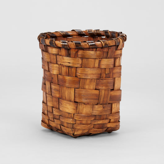 A WOVEN SPLIT CANE PAPER BASKET.