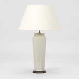 A PAIR OF FACETTED VASES OF TAPERING OCTAGONAL FORM IN A MOTTLED CELEDON GLAZE WIRED AS LAMPS.