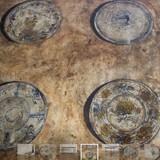 A 1960s/1970s SPANISH SIDE TABLE WITH A GILT METAL BASE AND LATER PAINTED DECORATION TO THE TOP.