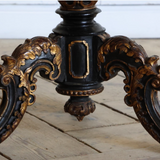 A 19TH CENTURY CHINESE EXPORT CENTRE TABLE WITH A LACQUERED AND DECORATED TILT TOP ON A CARVED AND GILDED BASE.
