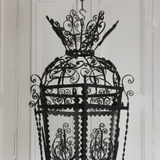 AN EARLY 20TH CENTURY HEXAGONAL SPANISH LANTERN IN FINE METAL SCROLL-WORK.