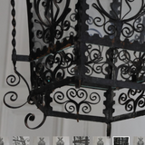 AN EARLY 20TH CENTURY HEXAGONAL SPANISH LANTERN IN FINE METAL SCROLL-WORK.