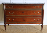 A 19TH CENTURY THREE-DRAWER MAHOGANY COMMODE IN THE LOUIS XVI TASTE, WITH A GREY MARBLE TOP AND BRASS MOUNTS.
