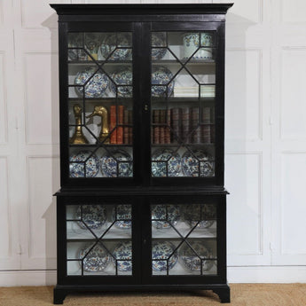 A 19TH CENTURY ENGLISH EBONISED GLAZED BOOKCASE IN THE LATE GEORGE III TASTE.