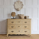 A 19TH CENTURY FRENCH BLEACHED OAK THREE DRAWER COMMODE.