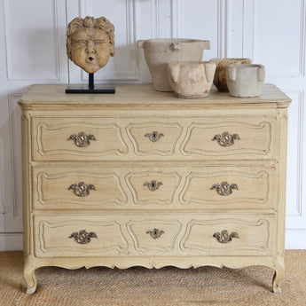 A 19TH CENTURY FRENCH BLEACHED OAK THREE DRAWER COMMODE.