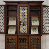 A VERY ELEGANT, 19TH CENTURY ENGLISH WILLIAM IV PERIOD INVERTED BREAKFRONT BOOKCASE IN ROSEWOOD, THE GLAZED DOORS WITH LATTICE AND ROSETTE BRASS GRILLS.