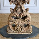 A MID 20TH CENTURY ITALIAN CENTRE TABLE WITH A PIETRA DURA TOP AND A CARVED AND GILDED BASE SET ON A MARBLE BASE.