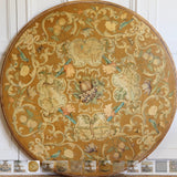 A MID 20TH CENTURY ITALIAN CENTRE TABLE WITH A PIETRA DURA TOP AND A CARVED AND GILDED BASE SET ON A MARBLE BASE.