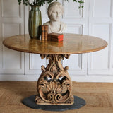 A MID 20TH CENTURY ITALIAN CENTRE TABLE WITH A PIETRA DURA TOP AND A CARVED AND GILDED BASE SET ON A MARBLE BASE.