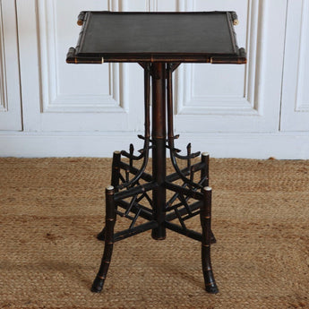 A LATE 19TH C. ENGLISH EBONISED BAMBOO AND BONE OCCASIONAL TABLE, WITH LEATHER LINED TOP.