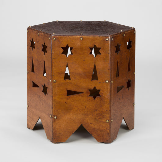 A SMALL LOW 1950s FRENCH HEXAGONAL TABLE WITH GEOMETRIC CUT-OUTS AND BRASS STUD DETAILING.
