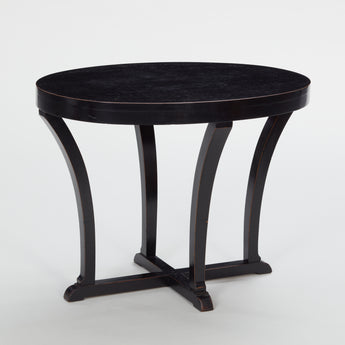 A LOW OVAL TABLE WITH INCURVED SUPPORTS MEETING A CRUCIFORM BASE. WITH A LATER EBONISED FINISH. CENTURY 1930s
