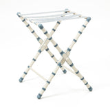 A HAND PAINTED TURNED WOODED LUGGAGE STAND (DESIGN DATING FROM THE 1950'S) FINISHED WITH A PATERAE BRAID.