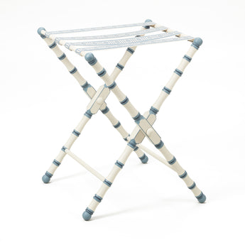 A HAND PAINTED TURNED WOODED LUGGAGE STAND (DESIGN DATING FROM THE 1950'S) FINISHED WITH A PATERAE BRAID.