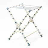 A HAND PAINTED TURNED WOODED LUGGAGE STAND (DESIGN DATING FROM THE 1950'S) FINISHED WITH A PATERAE BRAID.