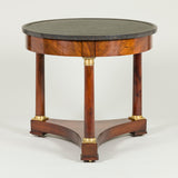 An early 19th century French mahogany round table with marble top, three column legs and a triform platform base.