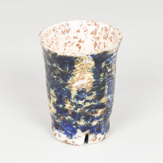 Five modern pottery beakers with a mottled blue glaze.