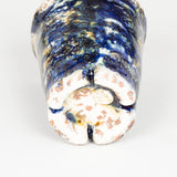 Five modern pottery beakers with a mottled blue glaze.