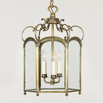 A pretty late 19th century English hexagonal brass hall lantern with an S-scrolled upper frame.