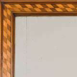 A late 19th century rectangular mirror, the walnut frame inlaid with marquetry banding.