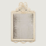 A small late 19th century mirror in a Louis XVI style with swag and bow crest and a later painted finish.