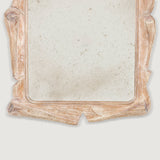 A rectangular mirror with an unusual mid-20th century asymmetrical limed carved oak frame.