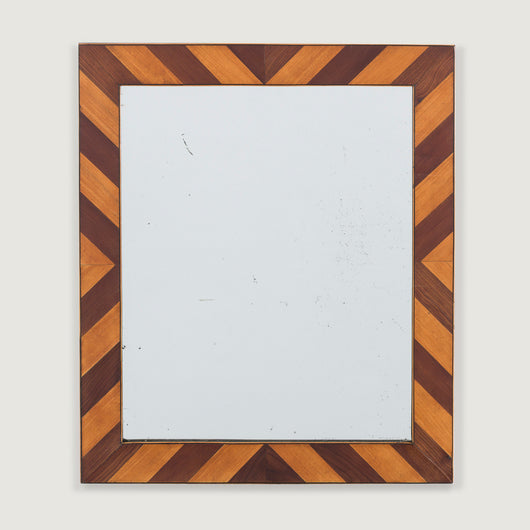 A small 19th century mirror, the frame made up of alternate chevrons of walnut and fruitwood inlay.