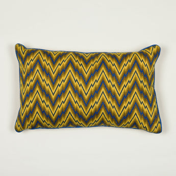 A blue and yellow flame-stitch cushion.