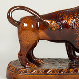 A treacle-glazed pottery lion. Probably late 19th century.