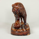 A treacle-glazed pottery lion. Probably late 19th century.