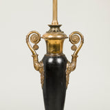 A pair of early 19th century French tole lamps, vase-shaped with brass mounts & handles, wired for electricity.