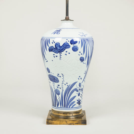 A pair of blue & white lamps decorated with aquatic plants and incised koi carp, mounted on square patinated brass bases. Chinese. Rewired.