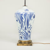 A pair of blue & white lamps decorated with aquatic plants and incised koi carp, mounted on square patinated brass bases. Chinese. Rewired.
