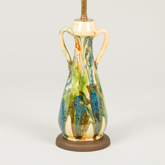 A small French art pottery vase with handles and green, blue and brown marbleised glazing on yellow.