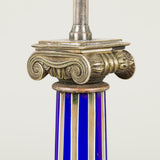 A pair of silver lamps in the form of Ionic columns with blue and white glass reeding, rewired.