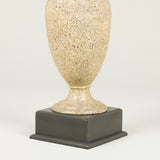 A painted metal vase lamp with a faux stone finish on a square wooden base. 20th century.
