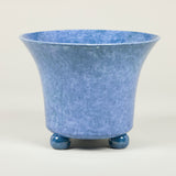 A large mottled tin glazed earthenware planter on bun feet in manganese or blue.