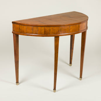 A pair of fruit-wood veneered demi-lune side tables with square tapered legs. Italian, circa 1800.